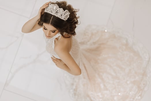 Top view, beautiful bride, with a white wedding dress and a luxurious crown on her head. Horizontal photo