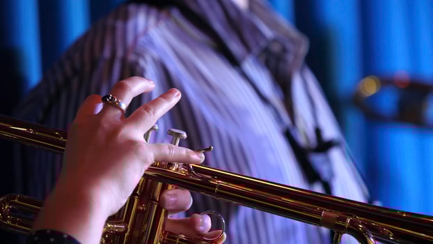 Trumpet player. Trumpeter hands playing brass music instrument close up photo