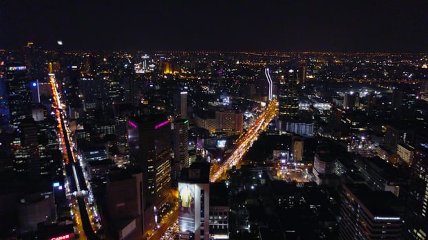 Aerial view of traffic at toll on expressway. Bangkok Expressway and Highway top view at dusk, Thailand. Aerial view of Bangkok buildings, Bangkok city downtown with sunset sky photo