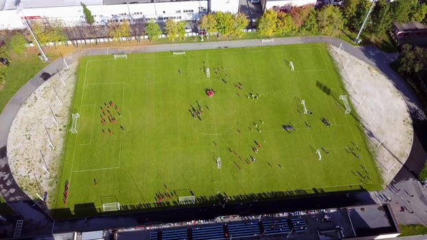Football players running around the football field. Top view of the football youth tournament photo