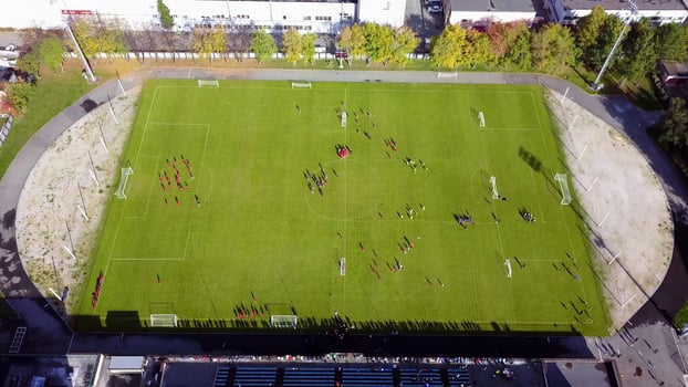 Football players running around the football field. Top view of the football youth tournament photo