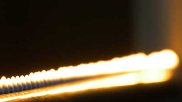 Pipe with fire in the chemistry laboratory close up. Gas system in the lab. Musical instrument with flames. Tube and fire close up photo