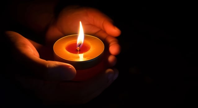 AI generated The candle is lit in a glass held by a beautiful woman in black. Isolated on the concept of saving the earth's energy. Earth hour photo