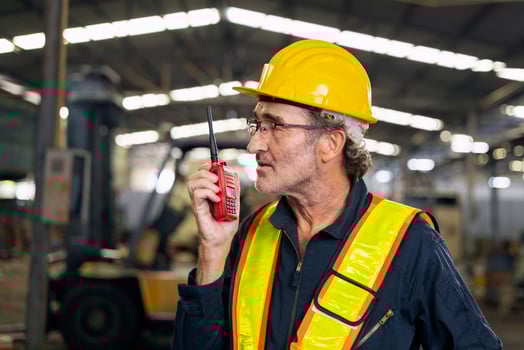 engineer use walkie talkie at machine factory photo