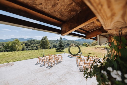 The wedding arch in the park is made of dry reeds on the background of the forest in blurred focus. Away wedding ceremony. Decorated chairs for the ceremony photo