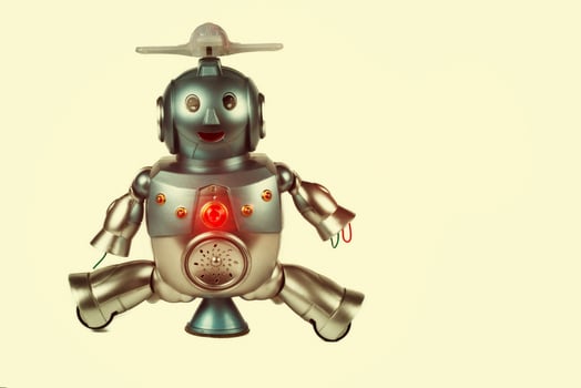 Vintage toy robot on a beige background. Robotics. photo