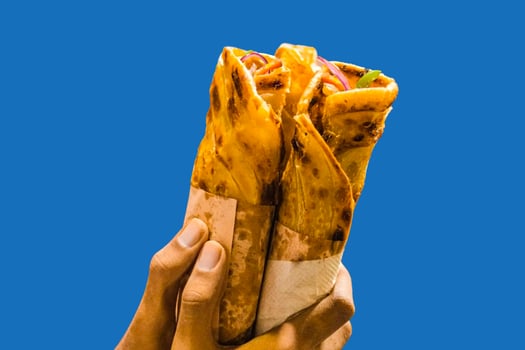 Egg chicken rolls in hand. Chicken Egg rolls. Chicken kathi roll, chicken wrap photo