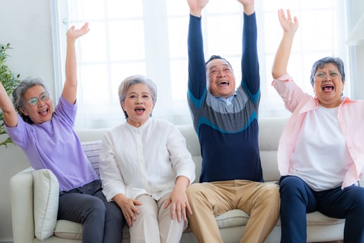Happiness of the group females and male elderly sitting on the sofa. Senior people are talking and enjoy together at the living room. Joyful carefree retired senior friends enjoying relaxation. photo