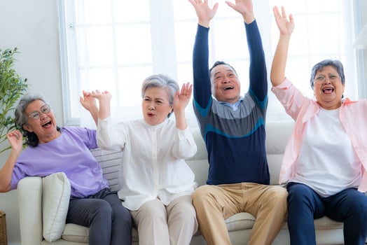 Happiness of the group females and male elderly sitting on the sofa. Senior people are talking and enjoy together at the living room. Joyful carefree retired senior friends enjoying relaxation. photo