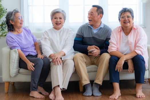 Happiness of the group females and male elderly sitting on the sofa. Senior people are talking and enjoy together at the living room. Joyful carefree retired senior friends enjoying relaxation. photo