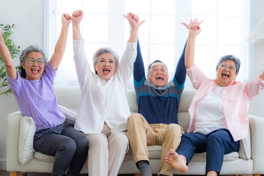 Happiness of the group females and male elderly sitting on the sofa. Senior people are talking and enjoy together at the living room. Joyful carefree retired senior friends enjoying relaxation. photo
