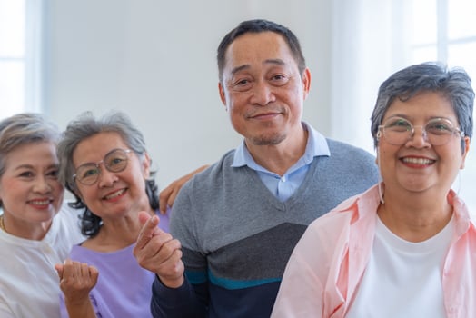 group of asian senior people standing with smart confidence. older people are listening and enjoy meeting focus group at living room. Joyful carefree retired senior friends enjoying relaxation. photo