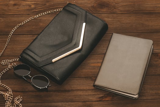 Black clutch bag with a chain and a notebook in a leather cover. photo