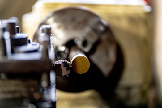 close up of machine operation for Metal Lathes. The steel column rolling in machine. metalworking industry. finishing metal working internal steel surface on lathe grinder machine with flying sparks photo