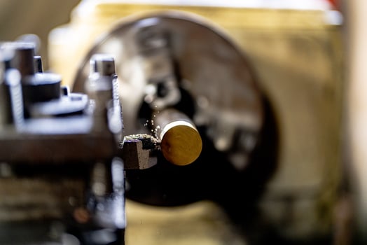 close up of machine operation for Metal Lathes. The steel column rolling in machine. metalworking industry. finishing metal working internal steel surface on lathe grinder machine with flying sparks photo