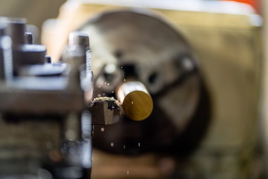 close up of machine operation for Metal Lathes. The steel column rolling in machine. metalworking industry. finishing metal working internal steel surface on lathe grinder machine with flying sparks photo