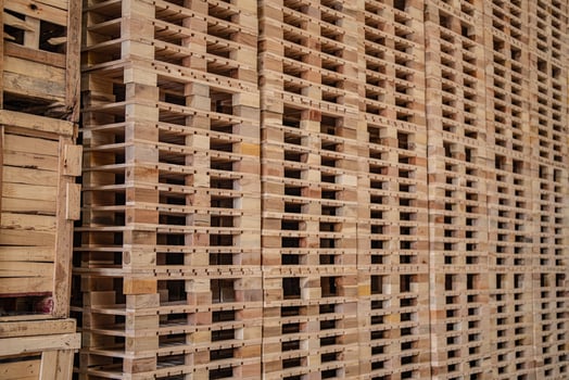background of pallet wood in warehouse. pattern wood section. Grid of wood squares. the raw of material timber on stack. photo