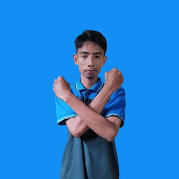 young asian male crossed arms with happy face isolated blue background photo
