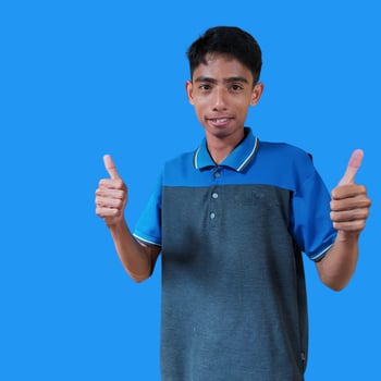 Happy smiling face of young Asian man in blue t-shirt on white background photo