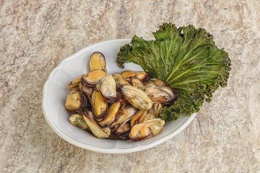Tasty marinated mussels in the bowl photo