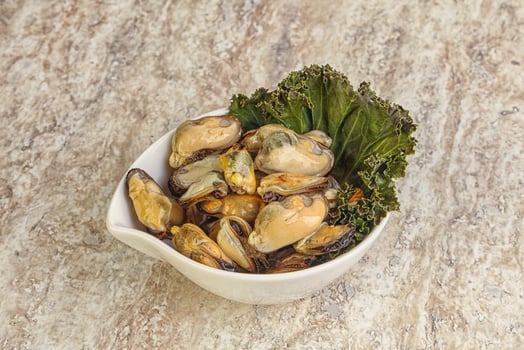Tasty marinated mussels in the bowl photo