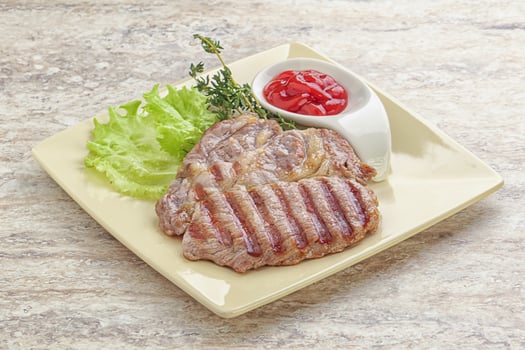 Grilled pork neck steak with ketchup photo