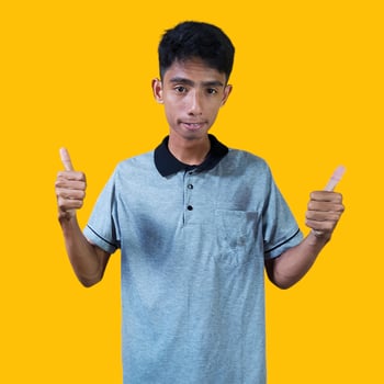 Asian man smiling face with okay gesture, isolated on blue background photo