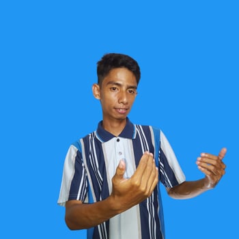 Young Asian man isolated on blue background inviting come with hands glad you came photo