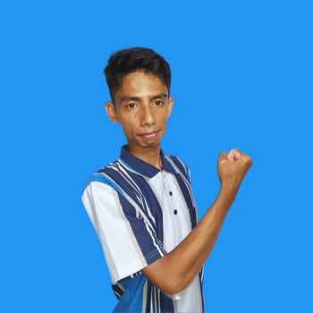 Excited Asian man wearing colorful t-shirt showing strong movement raising arms blue background. photo