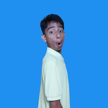 The young Asian man showed a surprised expression. wearing a yellow t-shirt. photo