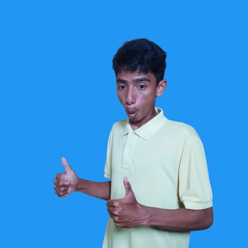 Asian man smiling face with okay gesture, isolated on blue background photo