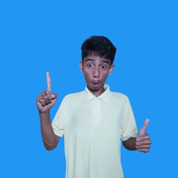 Asian man smiling face with okay gesture, isolated on blue background photo