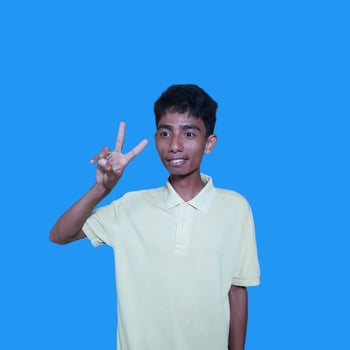 Excited Asian man wearing yellow t-shirt giving number 12345 hand gesture. blue background photo