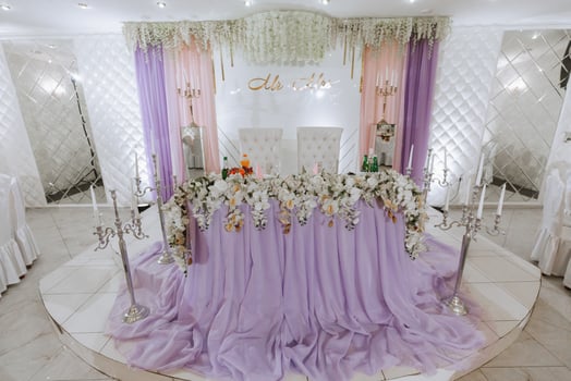 Presidium of the bride and groom at the wedding. Everything is almost ready for the wedding celebration. A wedding banquet, many flowers, a rich and refined wedding photo
