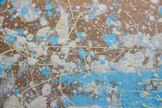 Abstract spots, drops of yellow blue white paint on a brown wooden surface photo