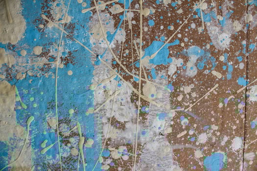 Abstract spots, drops of yellow blue white paint on a brown wooden surface photo