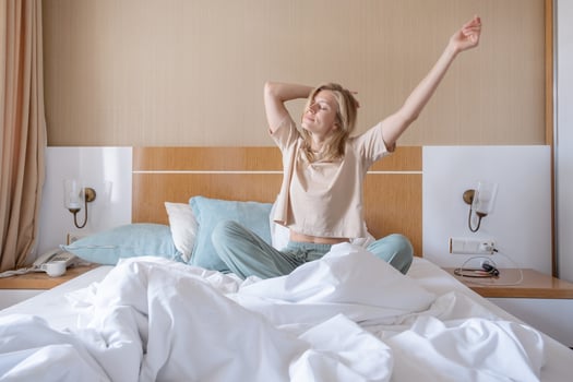 Woman stretching in bed after wake up photo