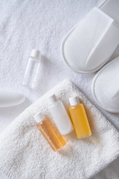Travel cosmetics kit on bed , top view photo