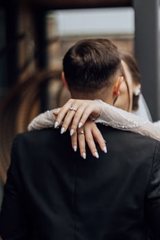 the bride hugs the groom and kisses him. Wedding concept, tender hands of the bride photo