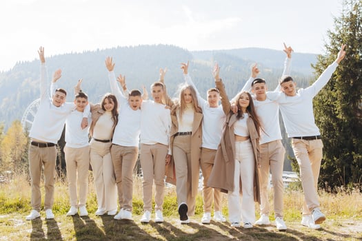 friendship, movement, action, freedom and people concept - group of happy teenagers or school friends jumping and having fun outdoors on the background of a beautiful place. photo