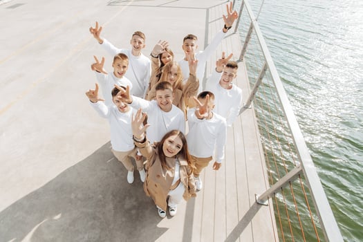 friendship, movement, action, freedom and people concepts - group of happy teenage students or school friends posing and having fun outdoors on beautiful place background. photo