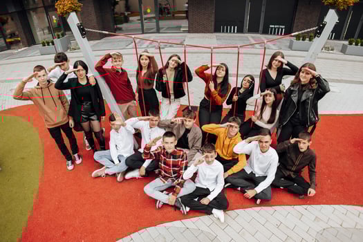 friendship, movement, action, freedom and people concept - group of happy teenagers or school friends posing and having fun outdoors on background of beautiful place or college. photo