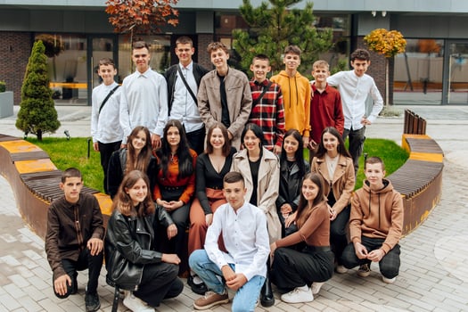 friendship, movement, action, freedom and people concept - group of happy teenagers or school friends posing and having fun outdoors on background of beautiful place or college. photo
