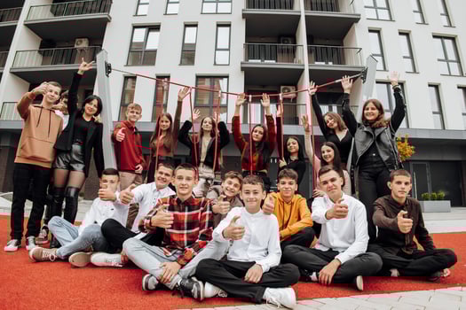 Group of many happy teenagers dressed in casual clothes having fun and having fun near college. Concept of friendship, moments of happiness. School friendship photo