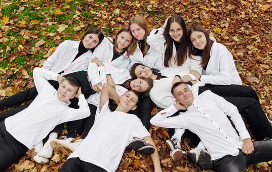 friendship, movement, action, freedom and people concept - group of happy teenagers or school friends posing and having fun outdoors against nature or forest background. photo