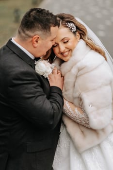 Wedding couple in love. A beautiful bride and an elegant groom tenderly embrace and enjoy the day. A stylish couple of newlyweds. Concept of marriage photo