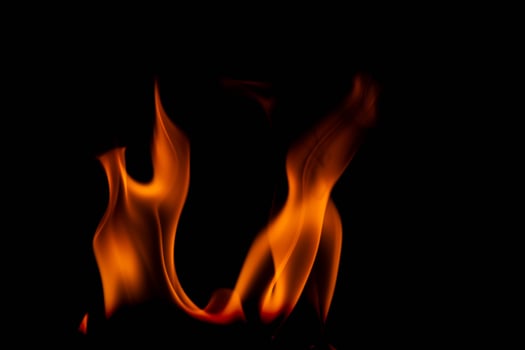 Hot flames on a black background. Beautiful flame of fire in the dark. Abstract of burning flames and smoke. photo