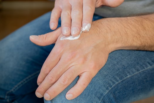 Hands of a man applying cream. photo