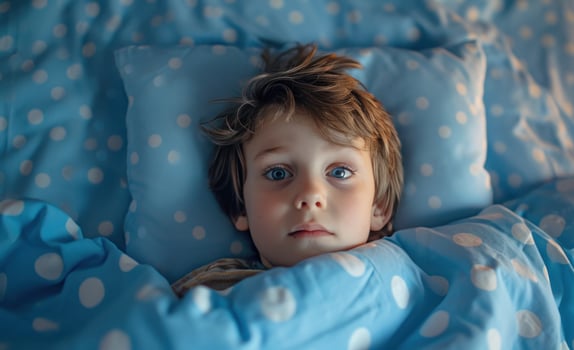 AI generated a little boy laying in bed with blue and white pillows around his head photo