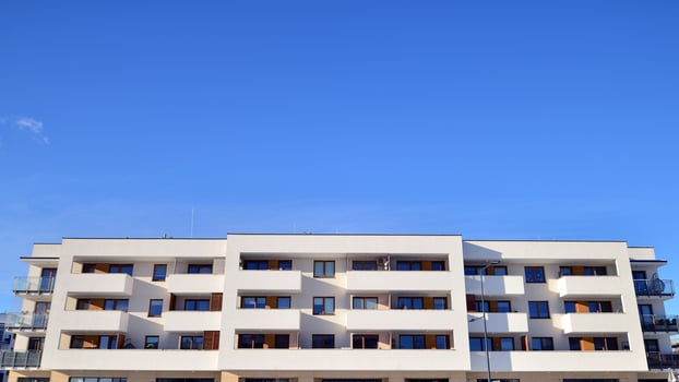 Modern apartment building in sunny day. Exterior, residential house facade. Residential area with modern, new and stylish living block of flats. photo